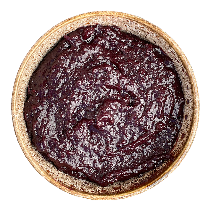 Bowl of dark red jam or jelly on a white background
